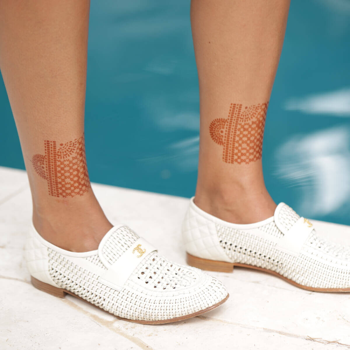 Atakapa - wrist cuff henna design near pool