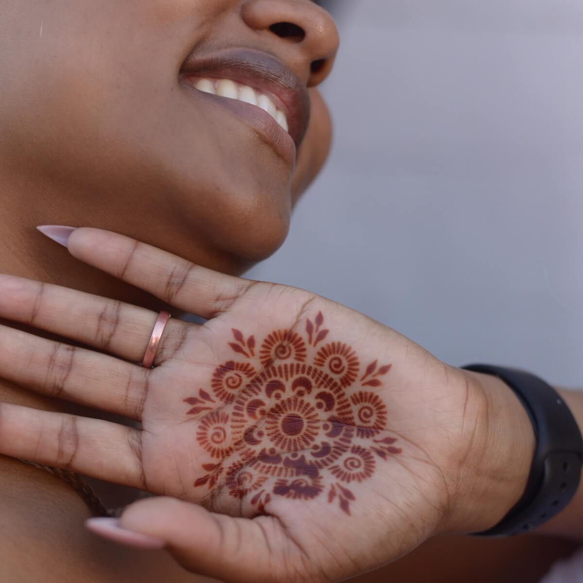 Passion Fruit - woman with mandala henna tattoo on palm