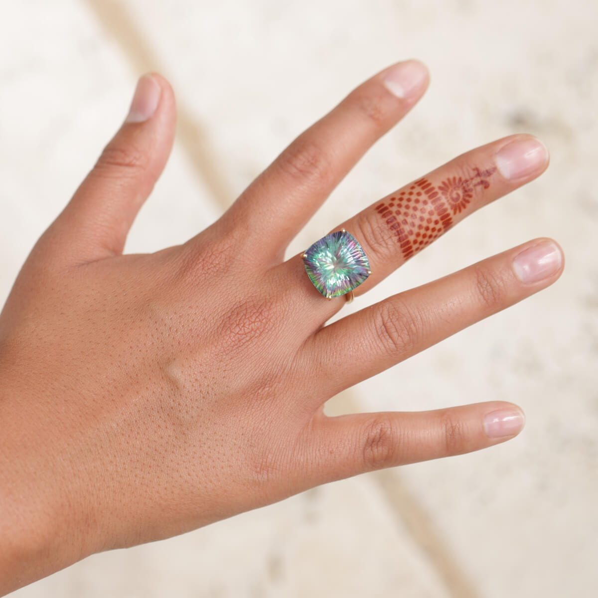 Radiant - woman with ring henna design on finger