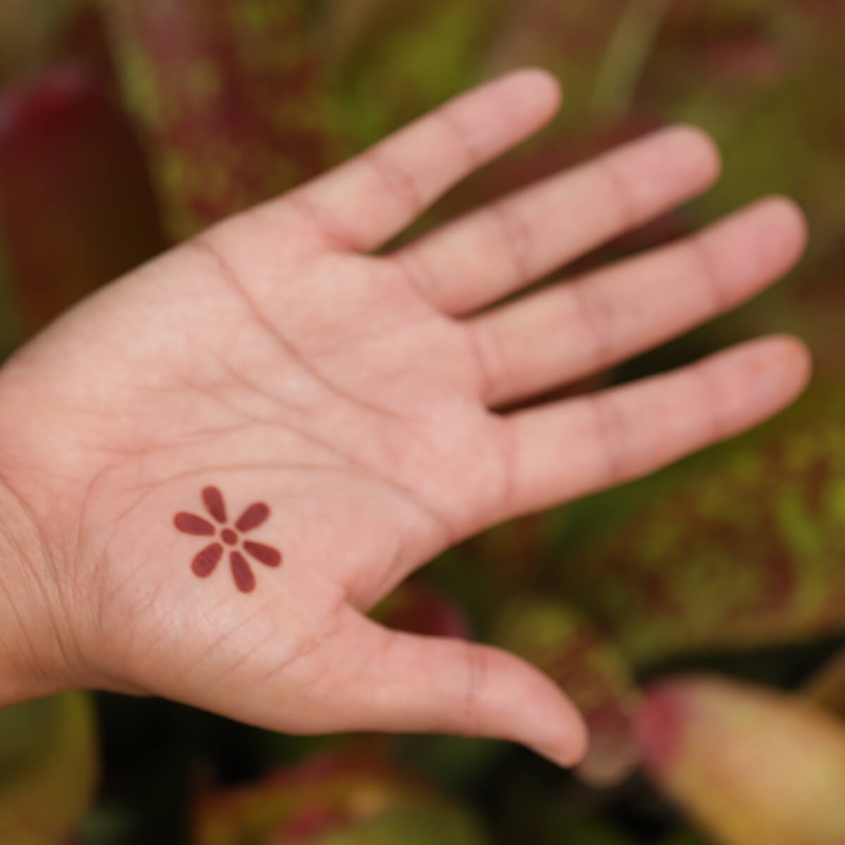 Truth - Blossoming Flower small accent henna tattoo on palm