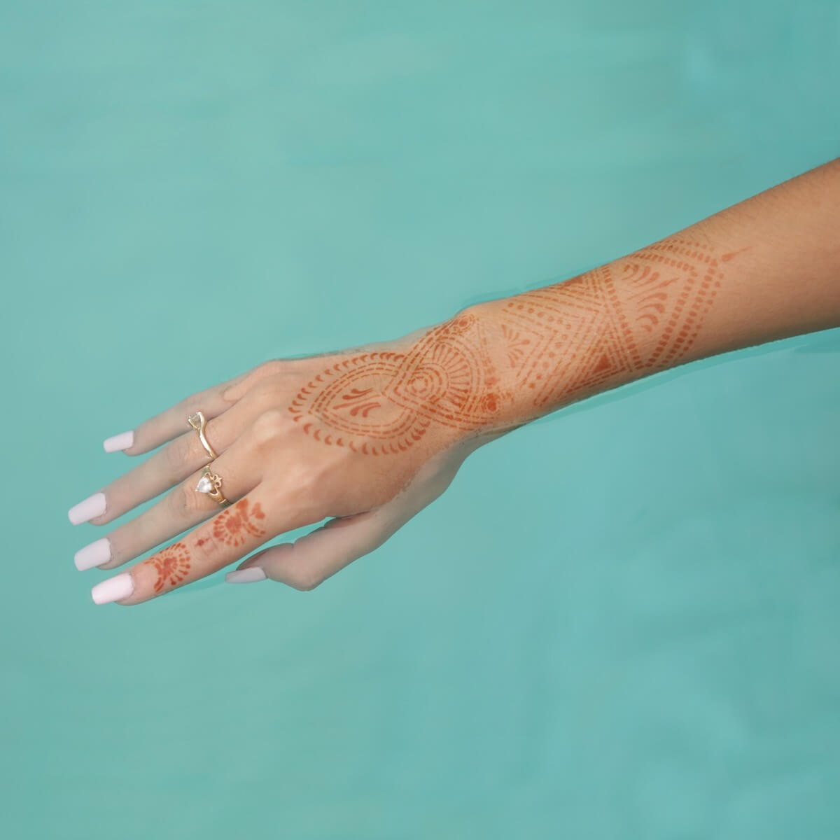 Zena - geometric henna tattoo on wrist in pool