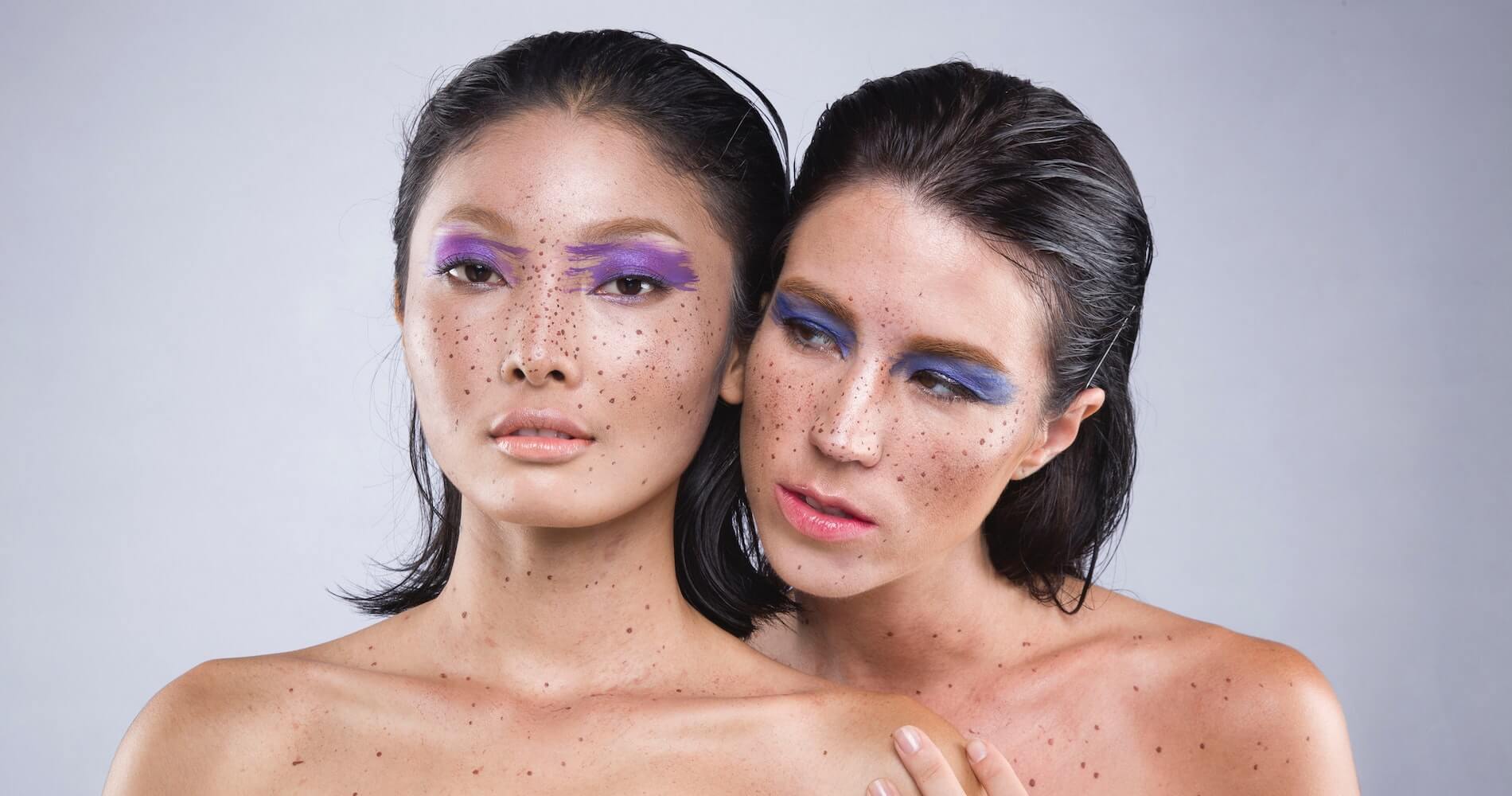 Two women with henna freckles on their faces