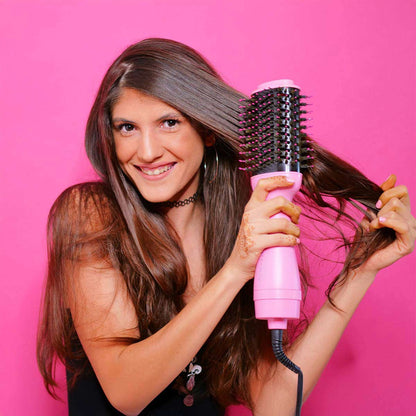 A Girl Using a Pink Hair Styling Tool on her Hair.