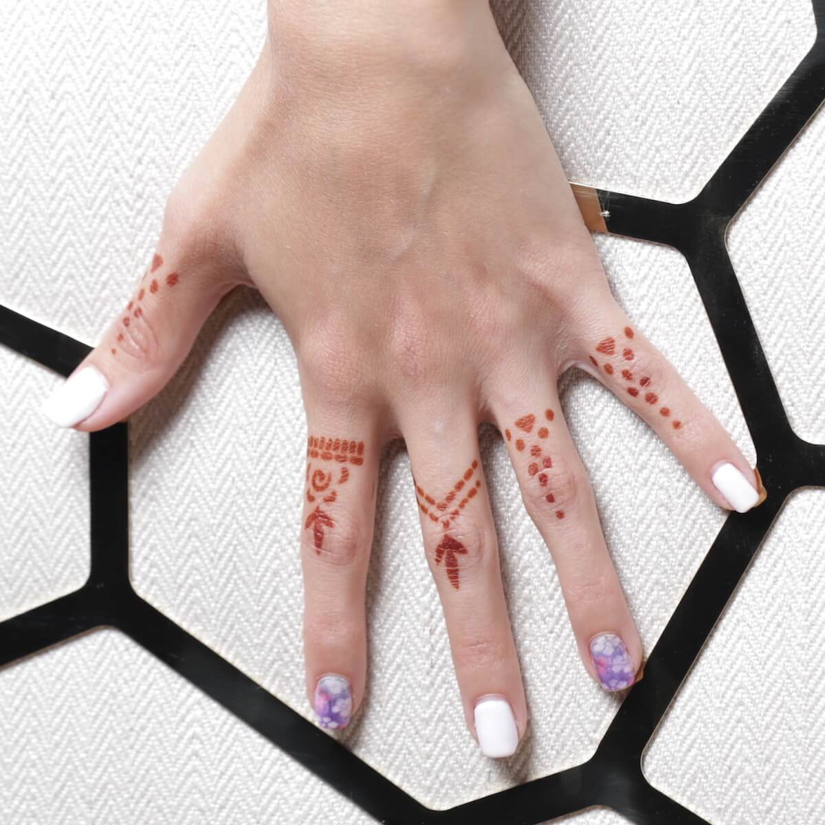 Aria - close up of finger henna tattoos