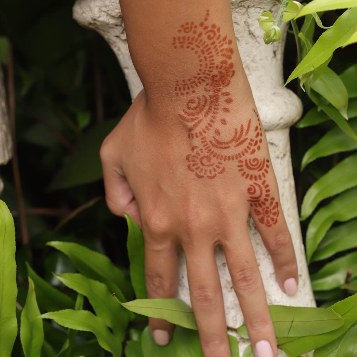 Athena - close up of back of hand henna design 