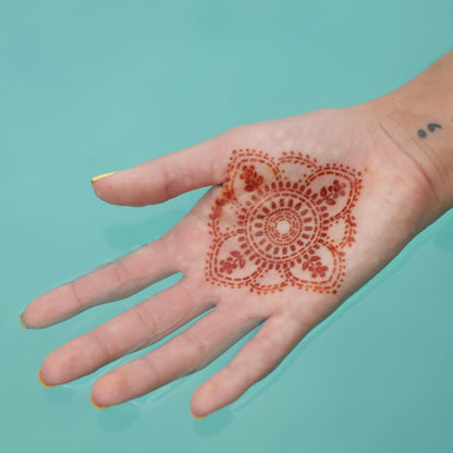 Blooms - mandala henna tattoo on palm in water