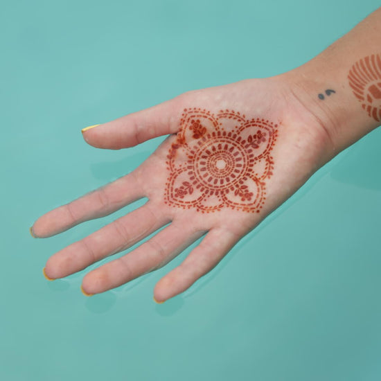 Blooms - mandala henna tattoo on palm in water