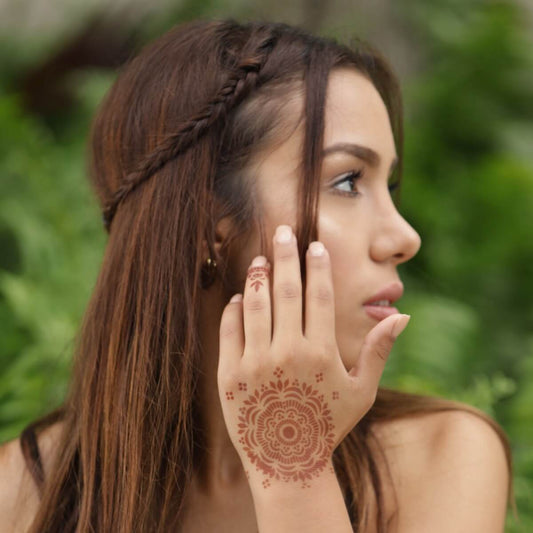Blossom - woman with mandala henna tattoo on back of hand