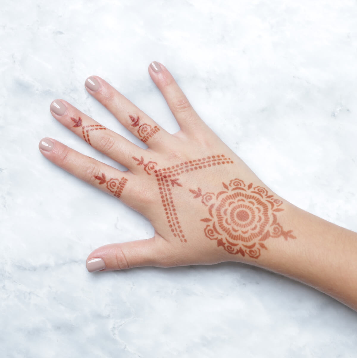Camellia - rings and mandala henna designs on back of hand