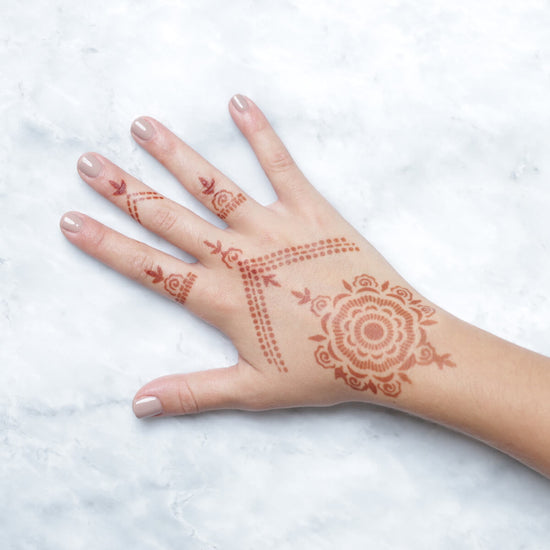 Camellia - rings and mandala henna designs on back of hand