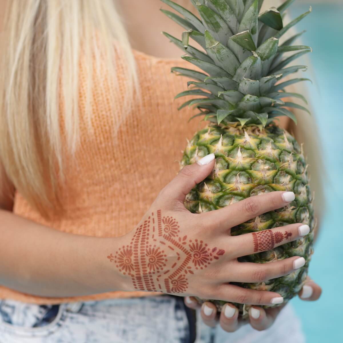Dahlia - woman with back of hand and ring henna design