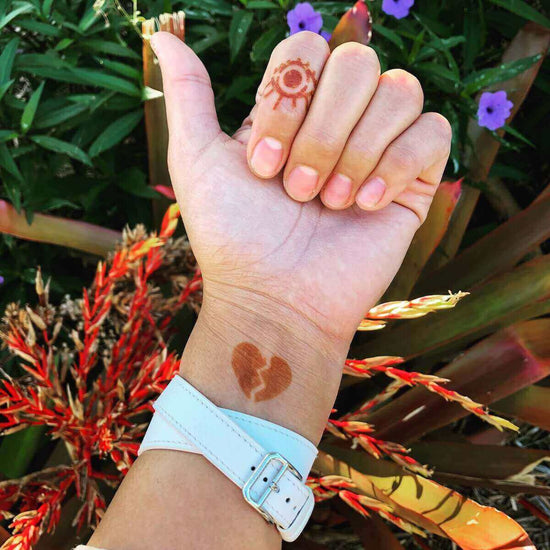 Dare - eye and broken heart henna tattoos on hand