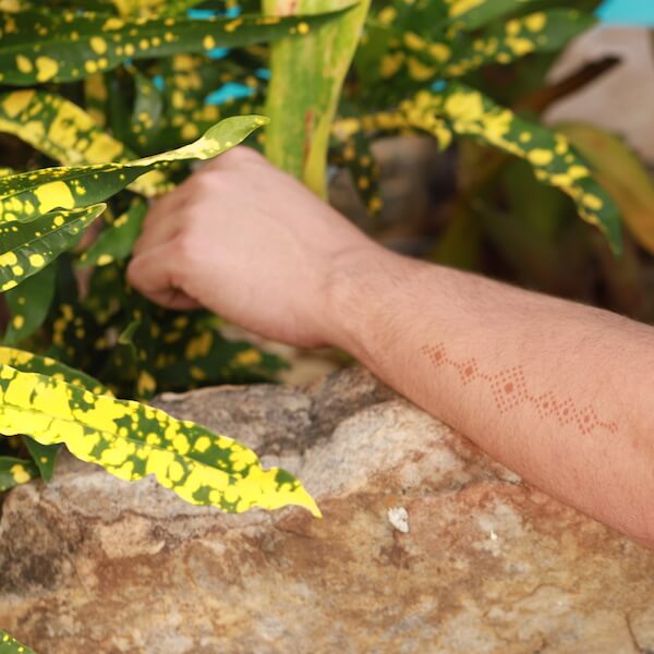 Karma - man with geometric henna design on forearm