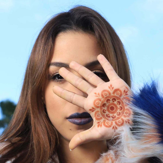 Passion Fruit - woman with mandala henna tattoo on palm
