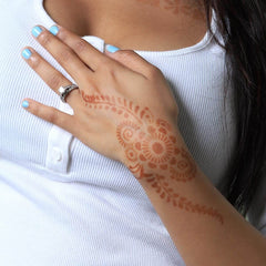 Phoenix - woman with henna tattoo on the back of her hand