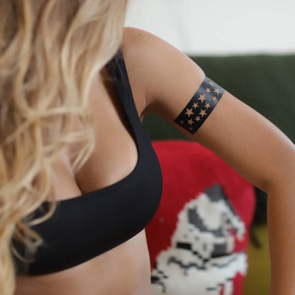 Stellar - woman using star henna design sticker stencil on upper arm