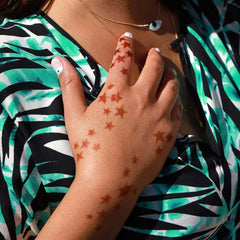 Stellar - star henna tattoo on back of hand