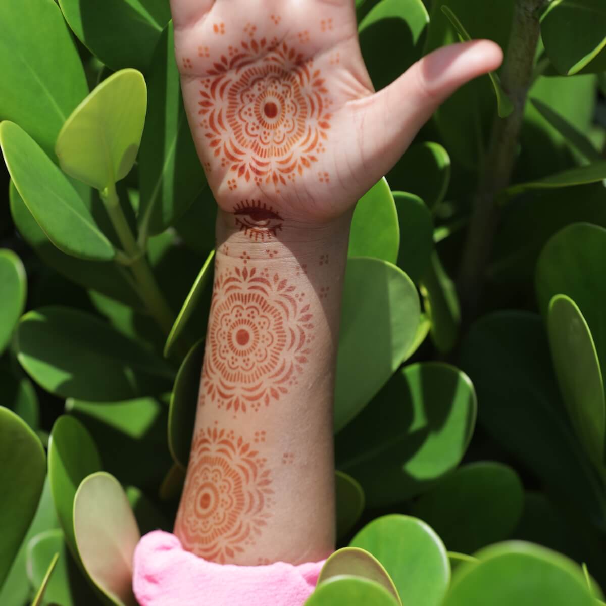 Blossom - multiple mandala henna tattoos along forearm