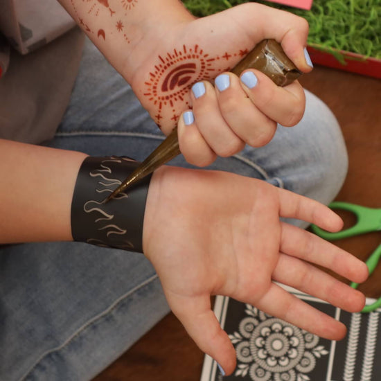 Flame Thrower - girl apply henna to a modern henna tattoo design