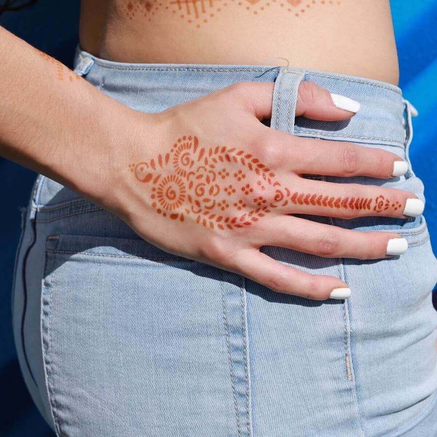 Woman with Marah henna tattoo on back of hand