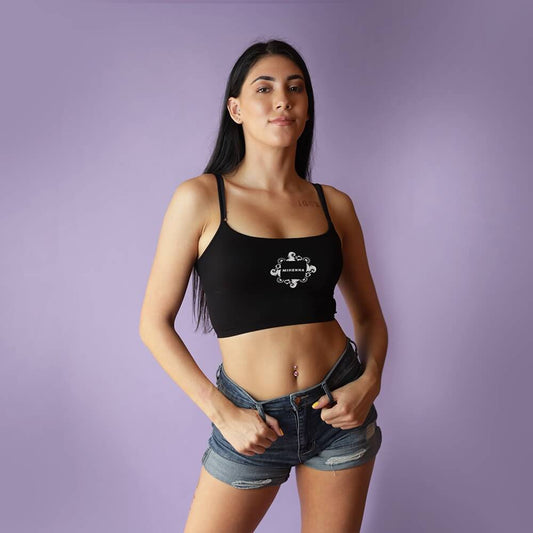 Young woman wearing black Mihenna crop top with jean shorts
