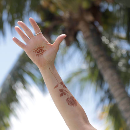 Rose - henna tattoo design of rose and evil eye on arm