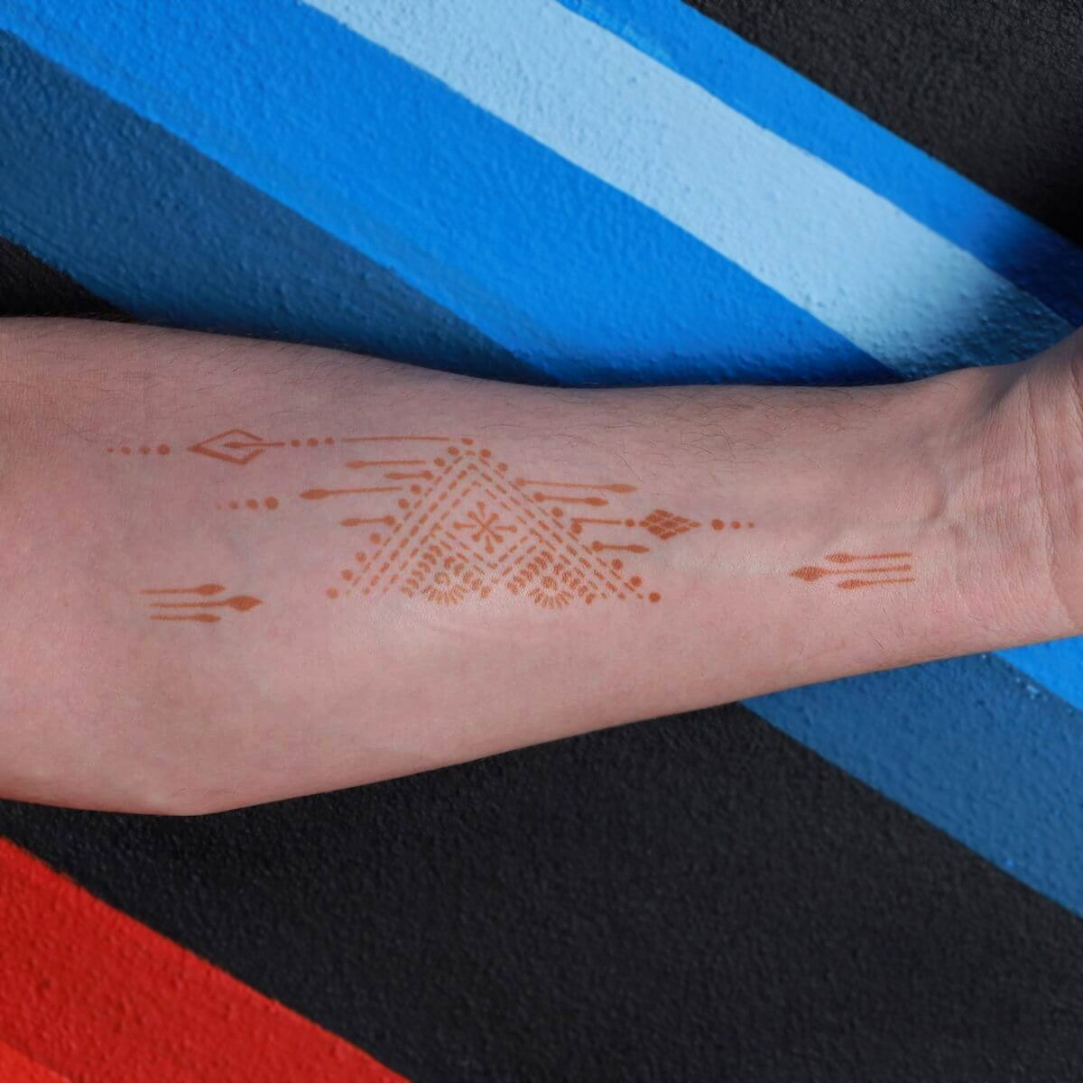 Ruma - Triangle and arrow henna tattoo on forearm