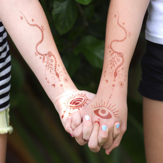 Sabrina - two girls holding hands with snake henna tattoos on arms