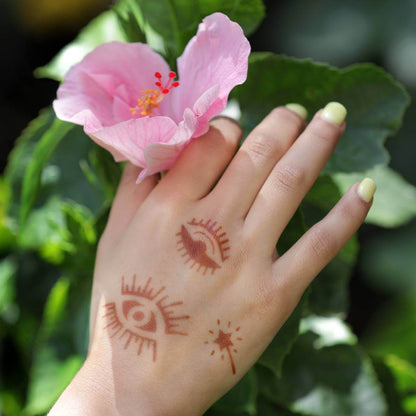 Sun - evil eye henna tattoos on hand