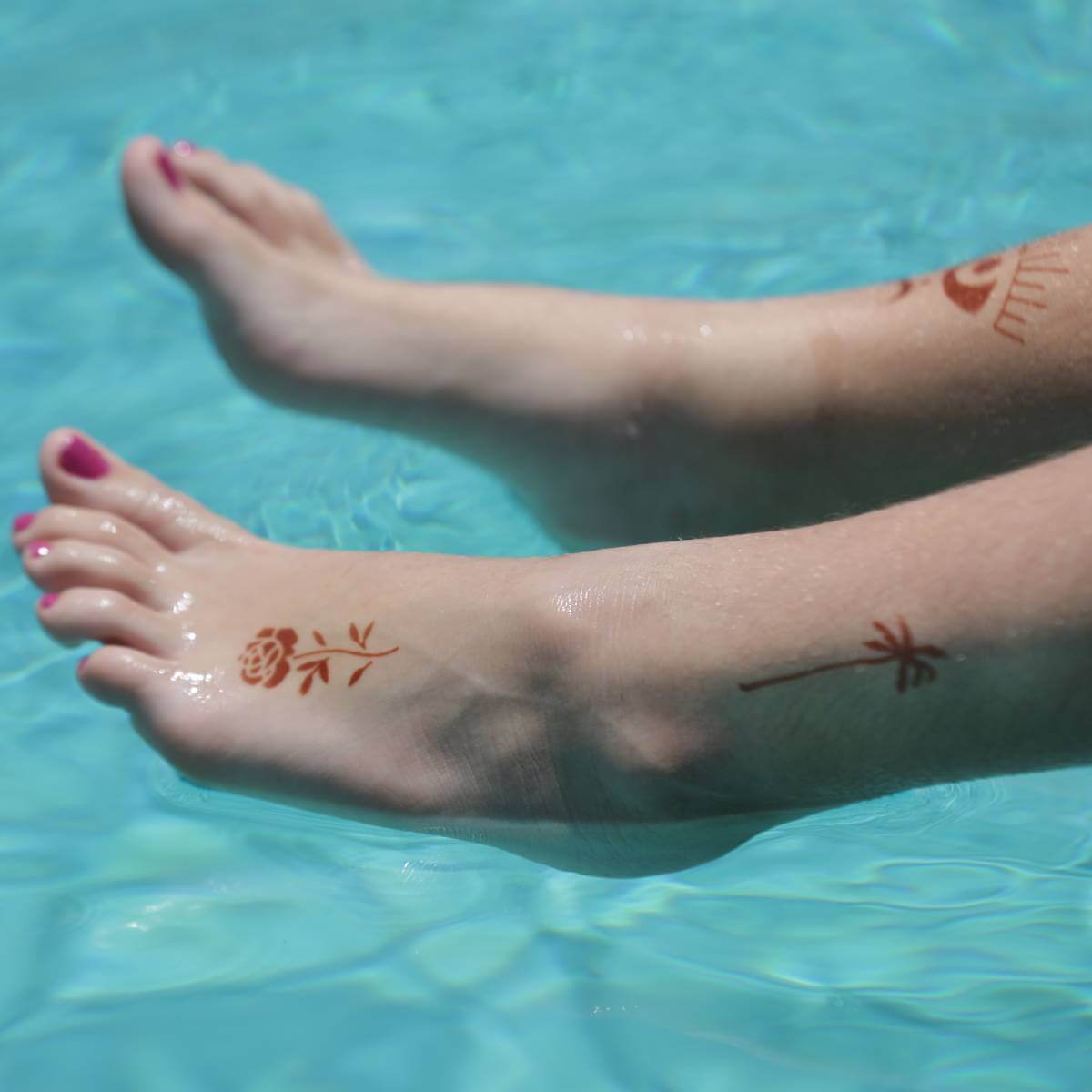 Sun - small rose and palm tree temporary tattoos on foot