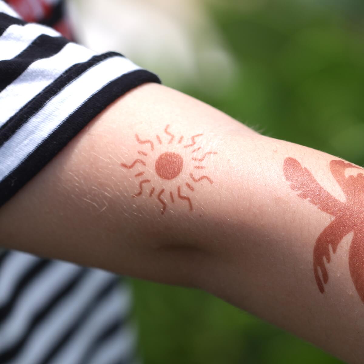 Sun - temporary tattoo of the sun on arm
