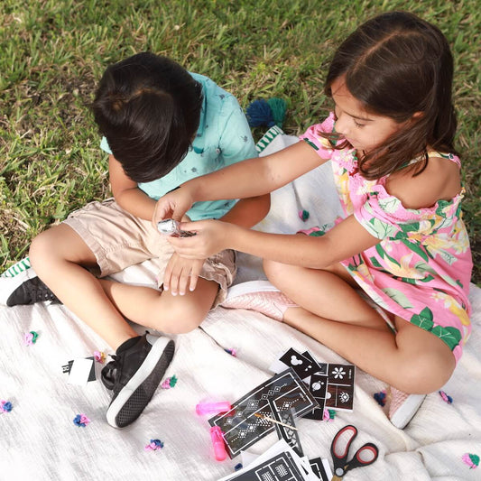 Kids Henna Tattoo Kit - two children applying henna tattoos