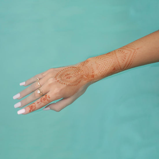 Zena - geometric henna tattoo on wrist in pool